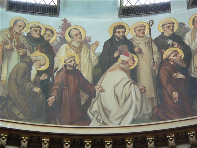 St. Alphonsus Liguori (1695-1787) and St. Ignatius of Loyola (1491-1556), whose feastdays we celebrate this week, are both depicted in a in a group of twelve figures identified as “Monks, Hermits, and Religious” in the dome of our church. St. Alphonsus, the first standing figure on the left, is pictured with a pen and book. Although he acquired fame as a writer, the founder of the Redemptorist Congregation is also remembered for his preaching and pastoral reforms. His feast is celebrated on August 1. St. Ignatius, fourth from the left (standing), was on his way to military fame before a debilitating war injury. His conversion experience began during his convalescence, and his writings during that time culminated in his greatest work, the Spiritual Exercises. Founder of the Jesuits, his feastday is July 31. The dome painting is by Buffalo-born artist Joseph Mazur; the photo by Gary Kelley.