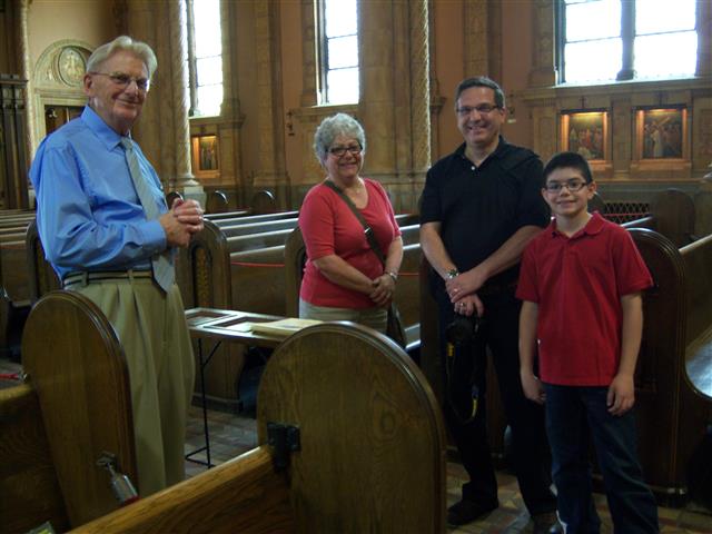 Docent Terry Gress (left) gives a visiting family his unique perspective on the nave and dome during Sunday's Sacred Sites Open House.