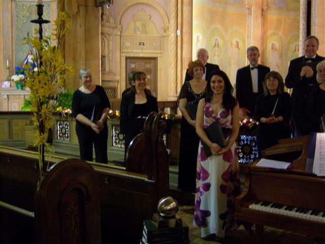 Members of The Freudig Singers, including BT choir members Elizabeth Sands (2nd from left) and Luis Clay (upper right) adknowledge audience applause at the end of their concert on May 3. Photo credit: Margaret Dick