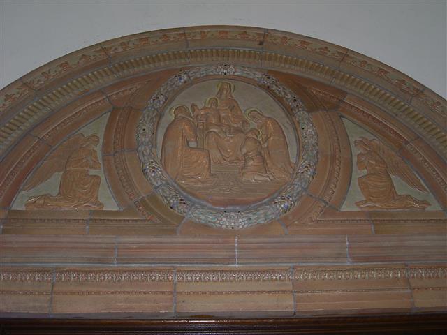“Adoration of the God-Man,” depicted in a large terra cotta relief in the church’s narthex, over the center front door ~ Scripture does not record the childhood meeting of Jesus and his cousin, John, but “it was a frequent medieval and Renaissance subject.” (Rev. Walter Kern’s “Guidebook to Blessed Trinity R. C. Church,” page 18).  On June 24, the Church celebrates the Nativity of St. John the Baptist.  Photo credit: Margaret Dick