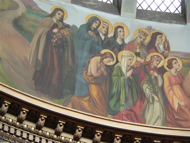 This week includes the feast days of two holy women who are depicted in Joseph Mazur’s procession of saints in the church dome. St. Elizabeth (November 17) who was the daughter of the King of Hungary wears a crown and appears as the second standing figure from the right. St. Cecilia (November 22), patron saint of musicians, is the kneeling figure at the far right. Photo credit: Gary Kelley.