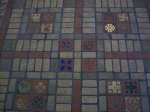 Detail from ceramic tile floor of Blessed Trinity Church: In addition to the 556 tiles depicting 24 different kinds of crosses, tiles pictured here feature an elephant (a symbol of Christ and the first man and woman), the Polish Falcon (love of one’s county); and a fish (another symbol of Christ or the month of February).