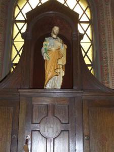 Statue of St. Joseph and hand carved cabinetry in Daily Mass Chapel.