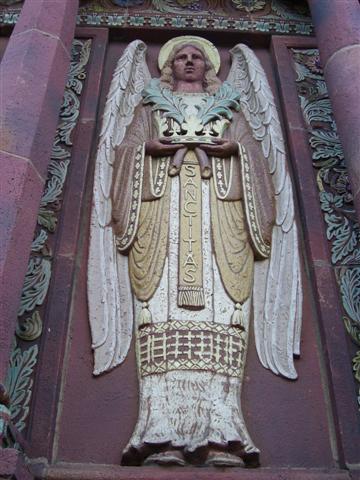 One of four angels on the church facade symbolizing the Four Marks of the Church: One, Holy [Sanctitas], Catholic, and Apostolic.