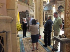 Visitors try to take it all in as docent Nancy Yager interprets the symbols about the Sacred Heart altar.