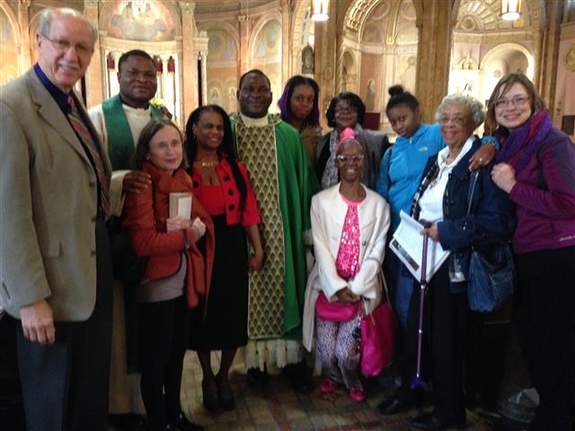 Father Victor Ibhawa (center) is welcomed by parishioners following Sunday Mass on November 6.